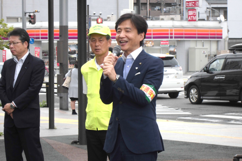 交通安全市民運動の街頭啓発であいさつしている様子の写真