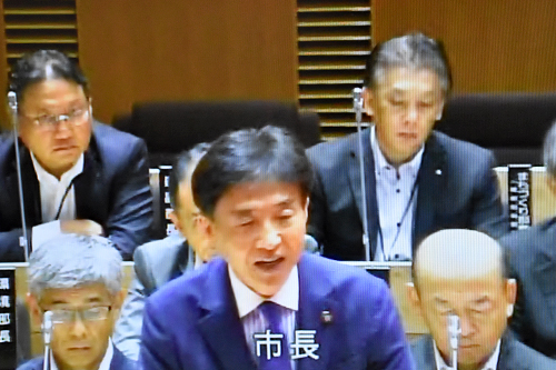 議会で発言する市長の写真