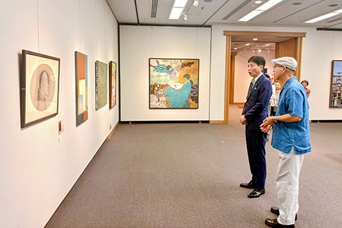 市長が作品の解説を聞きながら展覧会を鑑賞している様子の写真