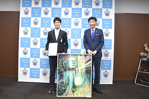 市長と来庁者が作品を前に記念撮影した写真