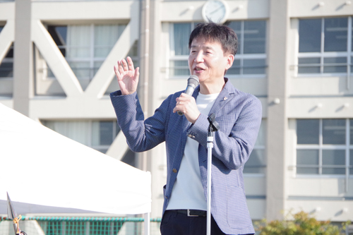 運動会で、市長がマイクを持ってあいさつしている様子の写真